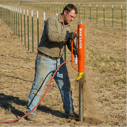 Man using a fence post driver in a field with 'Man-Saver' branding.